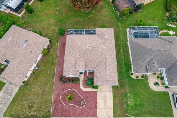 an aerial view of a house with a garden and swimming pool