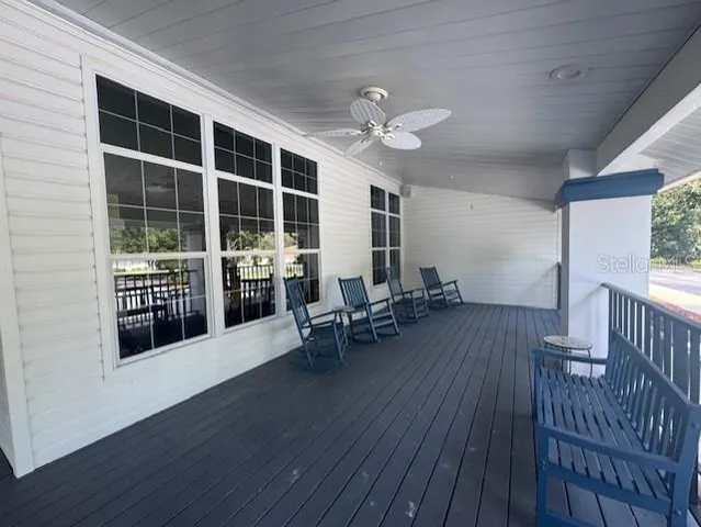 a view of a a dining room with furniture window and wooden floor