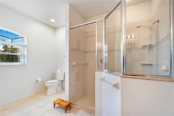 a bathroom with a toilet and a shower