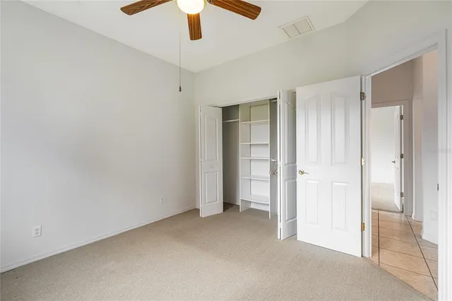 an empty room with closet area