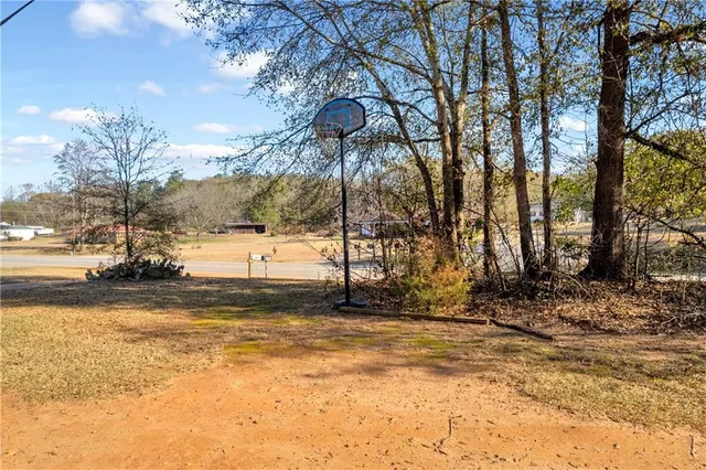a large bed sitting in a bedroom next to a window and a chandelier