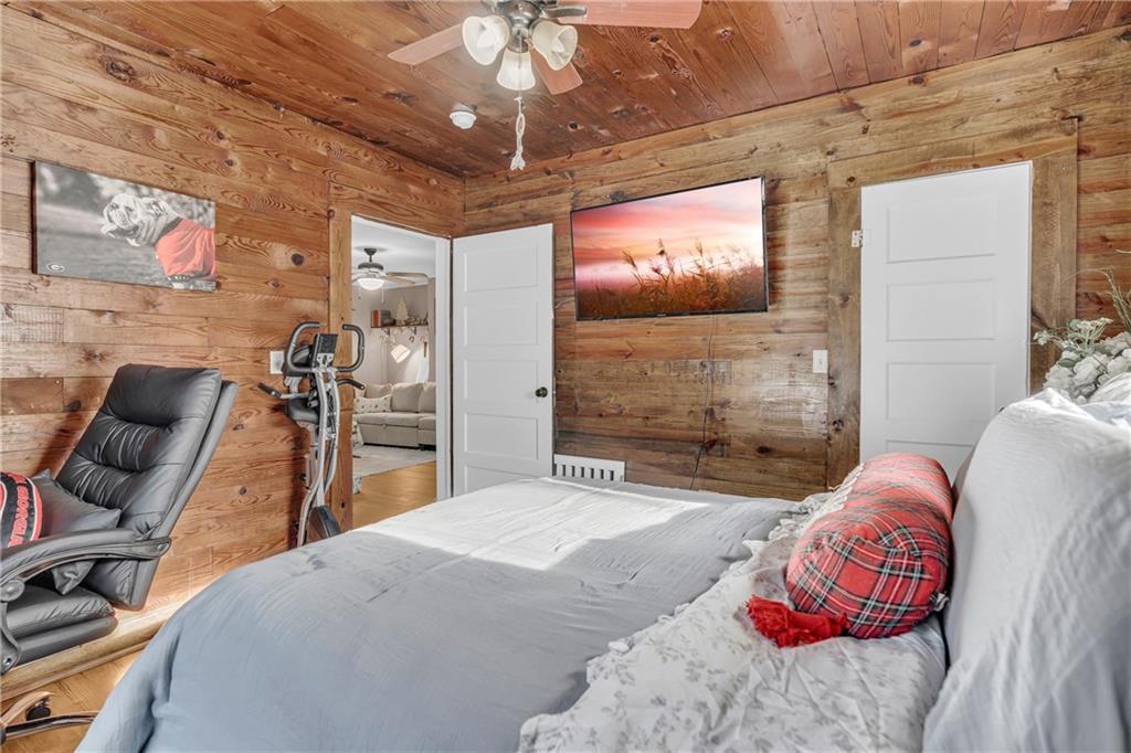 4106 Highway 29 Colbert, GA 30628 - Photo 72 of 82 a bedroom with a bed and a chandelier