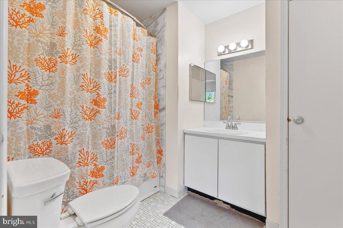 1795 Witherspoon Court Sewell, NJ 08080 - Photo 23 of 32 a bathroom with a sink a toilet and shower curtain