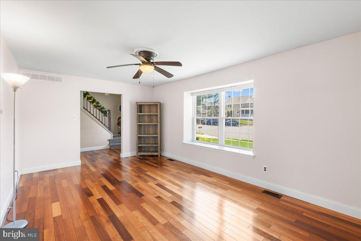 1795 Witherspoon Court Sewell, NJ 08080 - Photo 6 of 32 a view of an empty room with a window and wooden floor