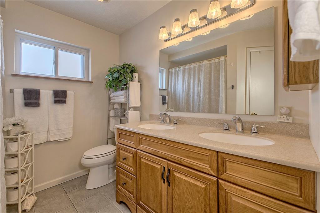545 Greenridge Road New Kensington, PA 15068 - Photo 15 of 28 a spacious bathroom with a granite countertop toilet sink and mirror