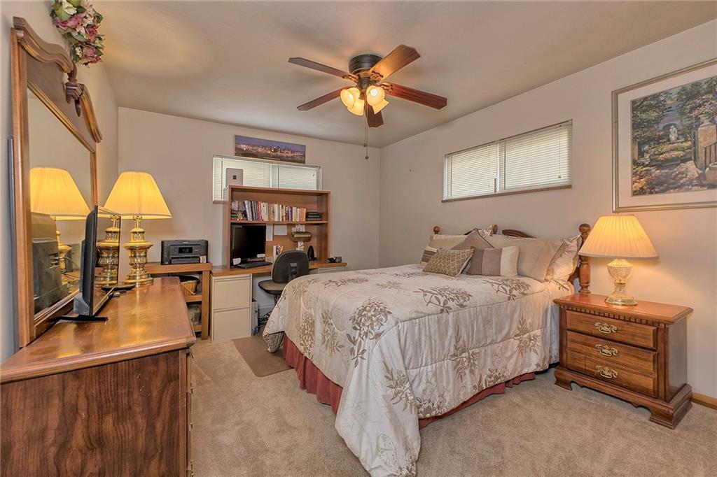 545 Greenridge Road New Kensington, PA 15068 - Photo 18 of 28 a bedroom with a bed and a chandelier