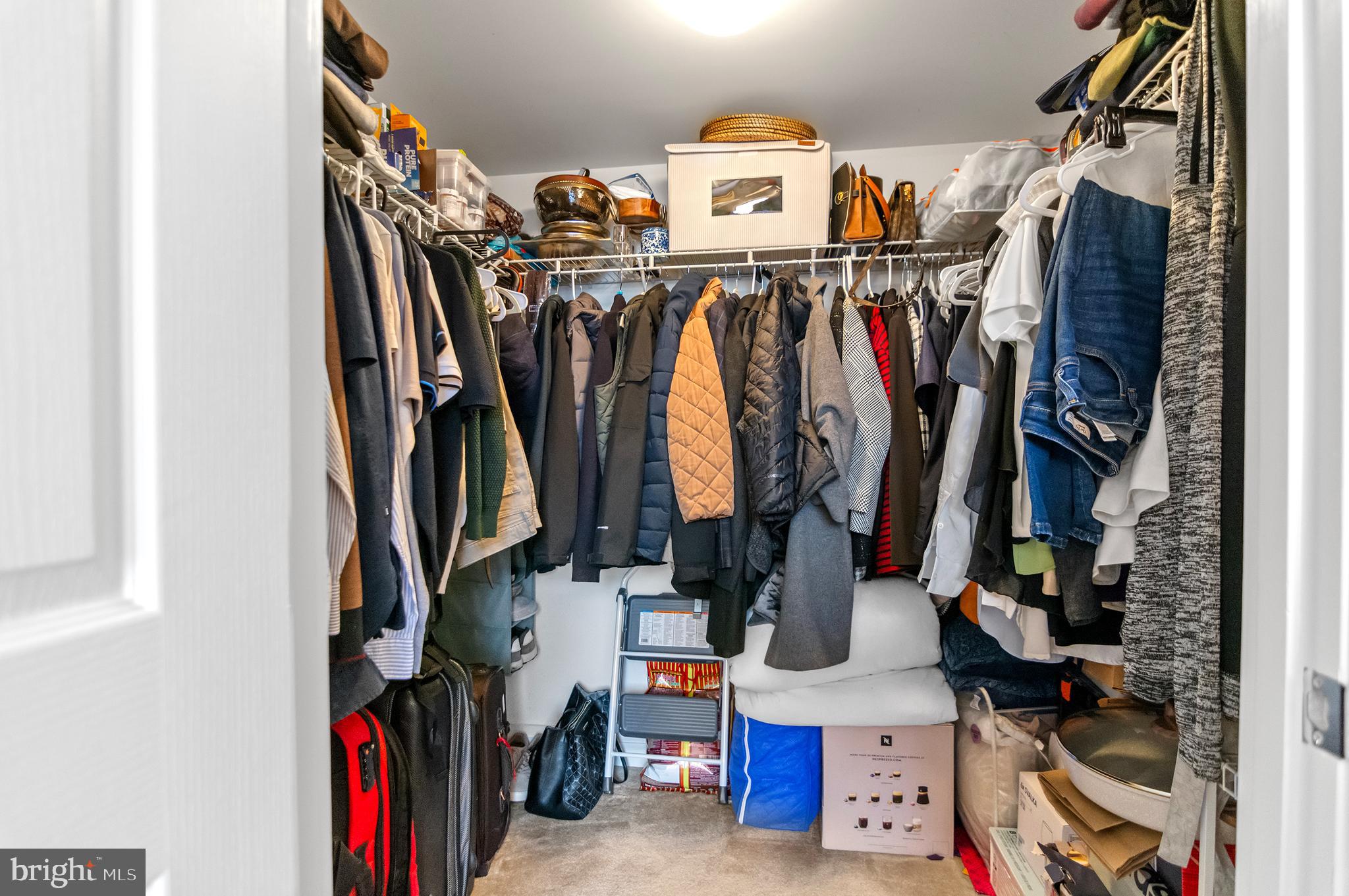 414 Water Street, Unit 2504 Baltimore, MD 21202 - Photo 13 of 20 a view of walk in closet with clothes and shoes
