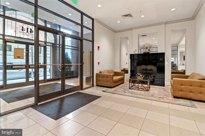 414 Water Street, Unit 2504 Baltimore, MD 21202 - Photo 17 of 20 a lobby with furniture and a fireplace