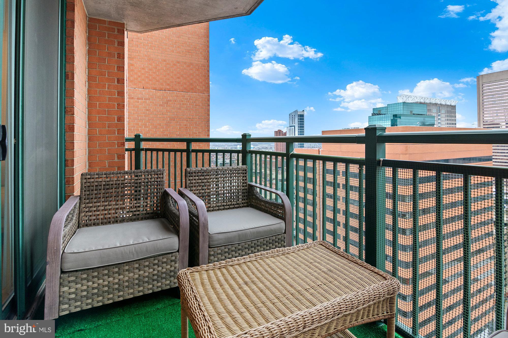 414 Water Street, Unit 2504 Baltimore, MD 21202 - Photo 3 of 20 a view of a balcony with wooden floor
