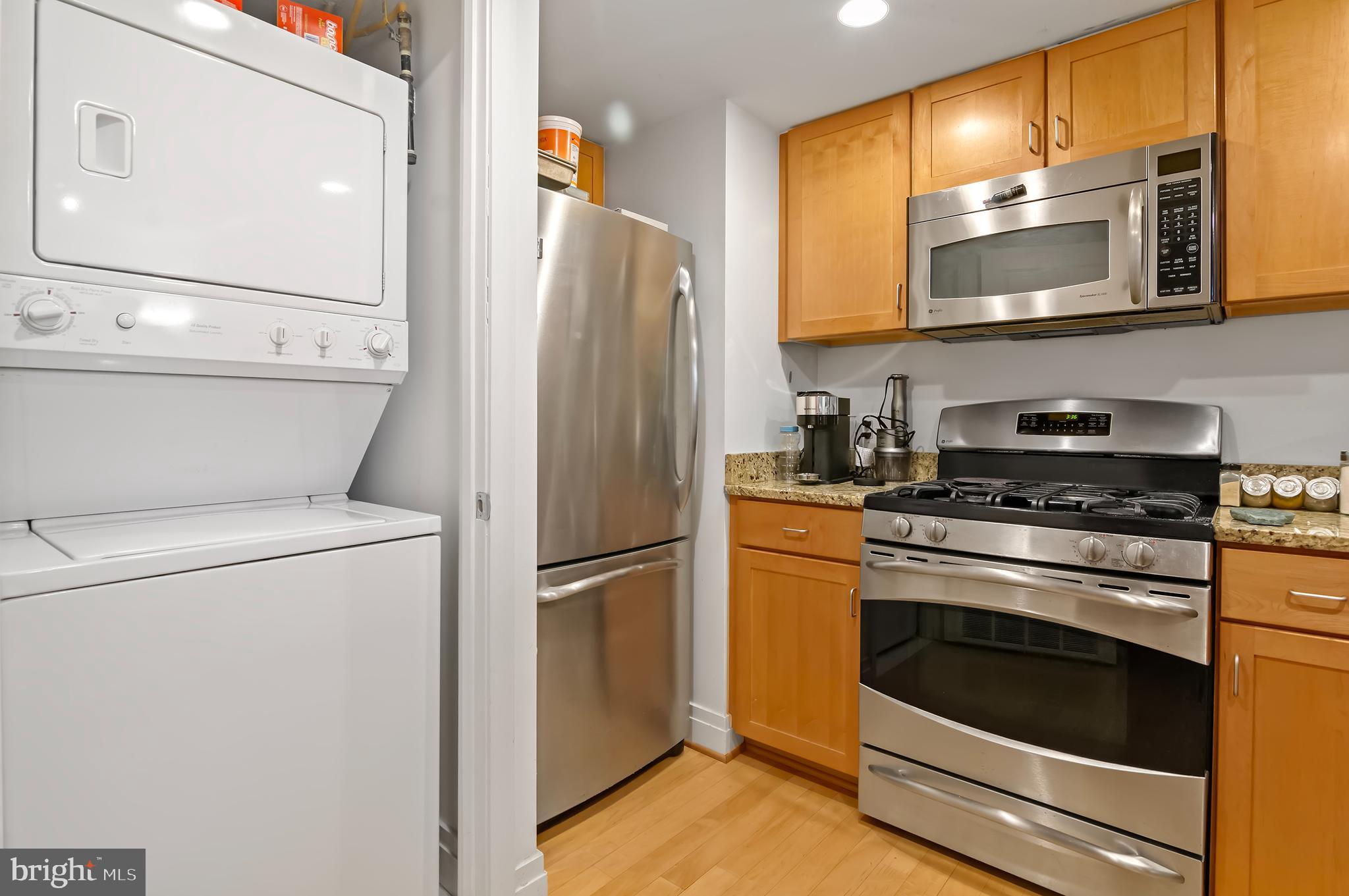 414 Water Street, Unit 2504 Baltimore, MD 21202 - Photo 7 of 20 a kitchen with a refrigerator sink and stove top oven