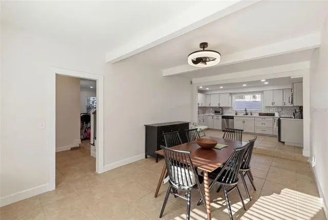 a living room with furniture a baby crib and a window