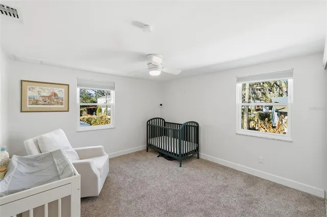 a front view of a house with a garden and trees