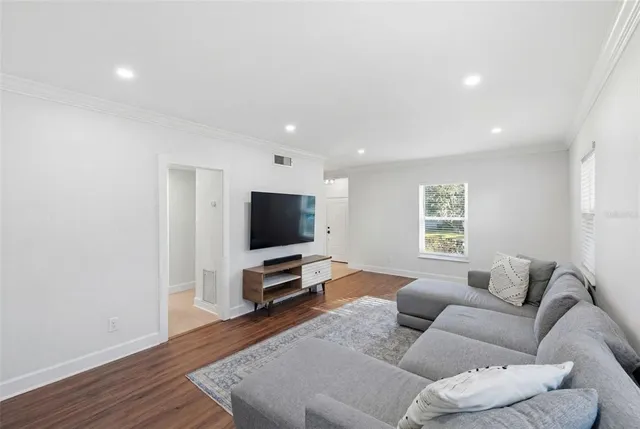 a kitchen with granite countertop a stove cabinets and chairs