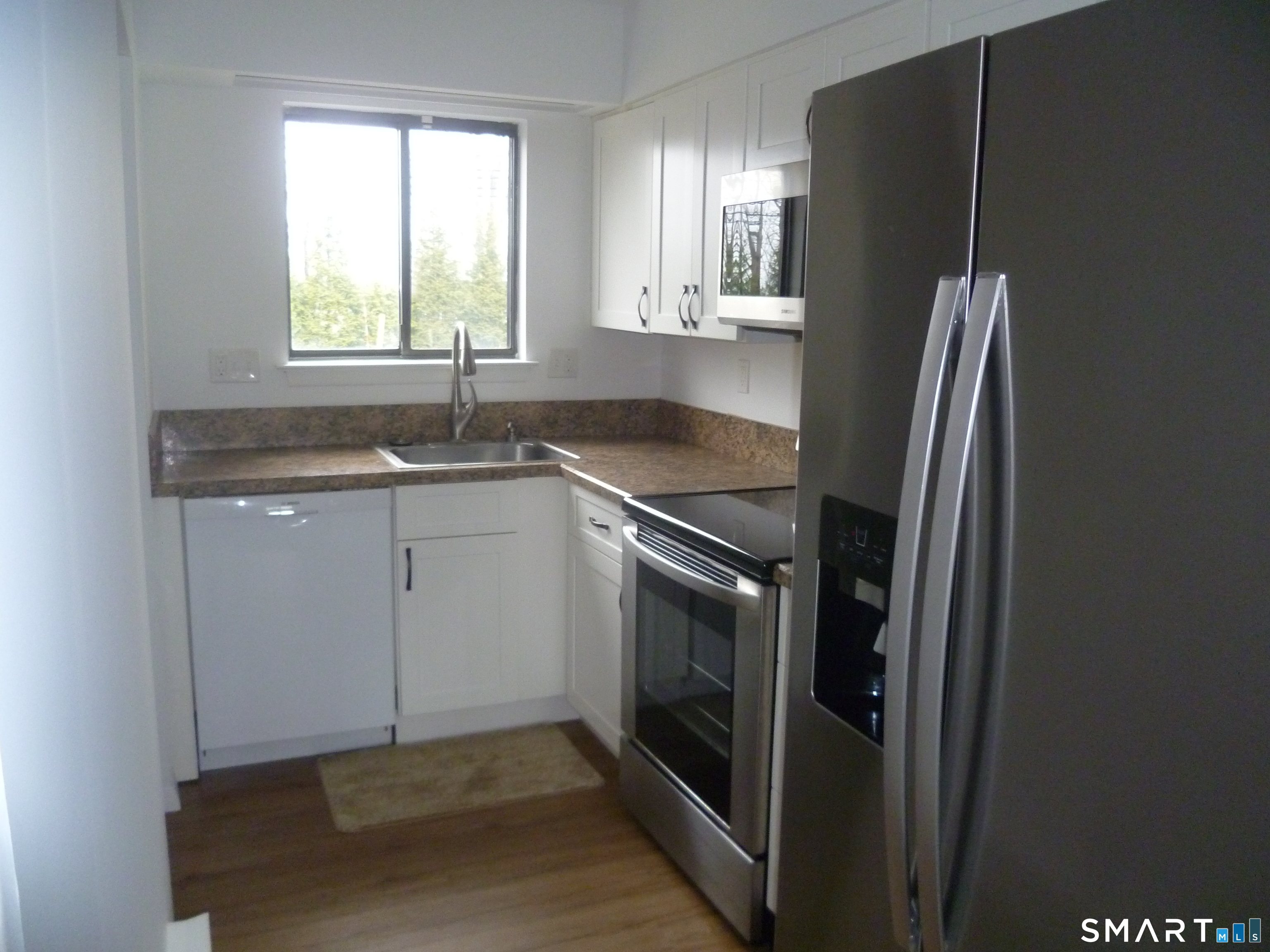 560 Yale Avenue, Unit 4 Meriden, CT 06450 - Photo 2 of 8 a kitchen with stainless steel appliances granite countertop a refrigerator sink and window