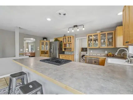 a kitchen with stainless steel appliances granite countertop a stove and a sink