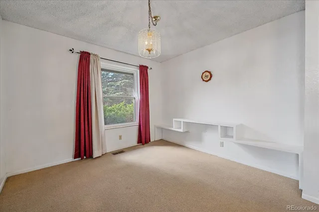 a view of empty room with floor to ceiling window