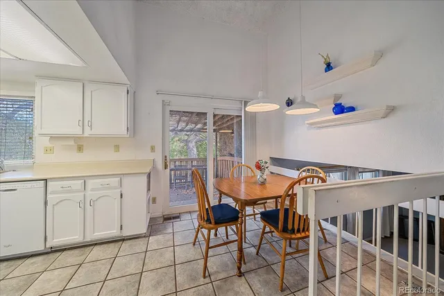 a kitchen with granite countertop cabinets and chairs