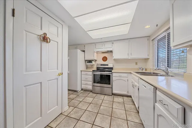 a kitchen with a stove a sink and a refrigerator