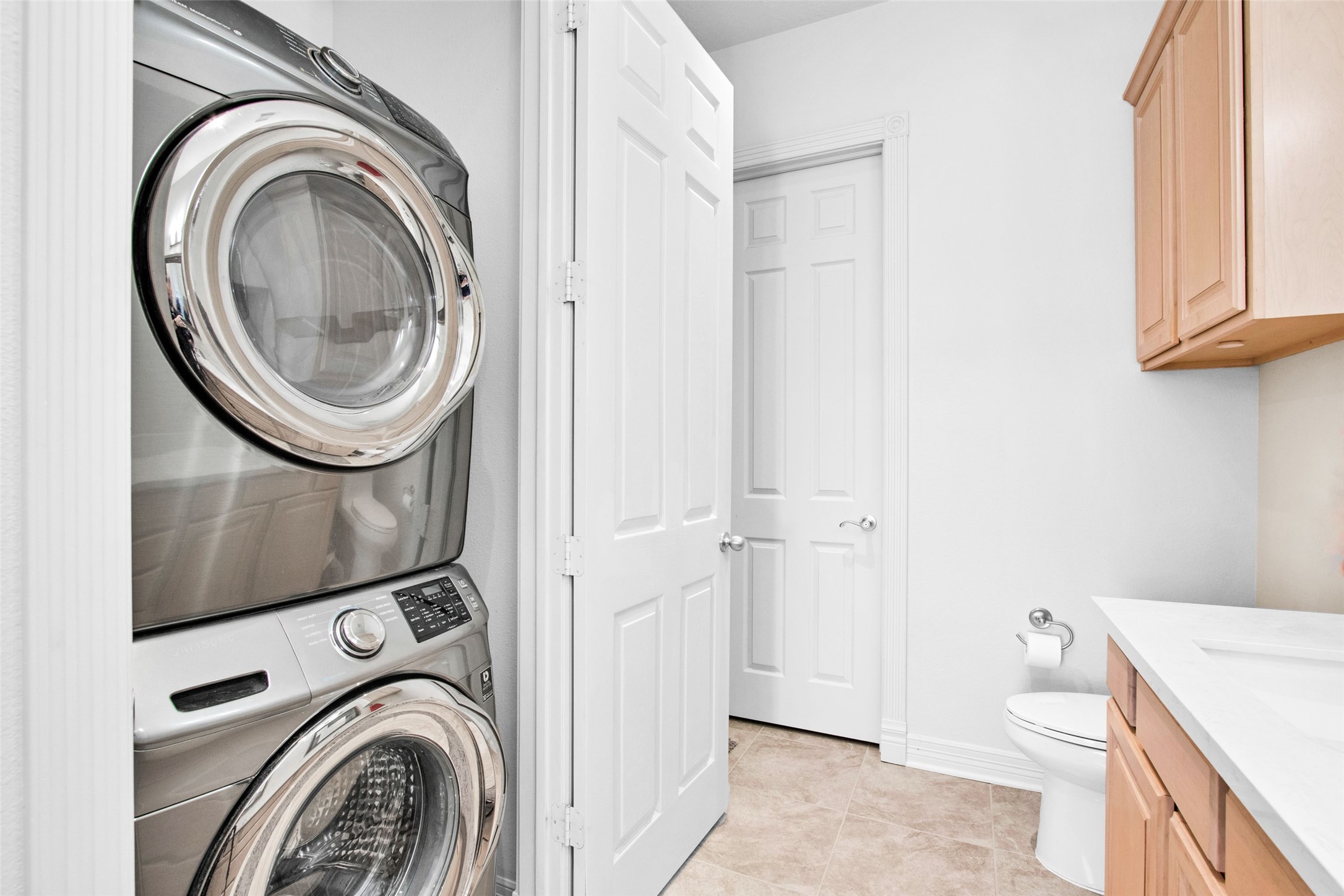 168 Lake Point Boulevard Conroe, TX 77356 - Photo 16 of 24 a view of a bathroom with washing machine and a sink