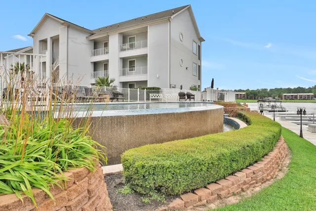 a view of a house with a swimming pool and sitting area