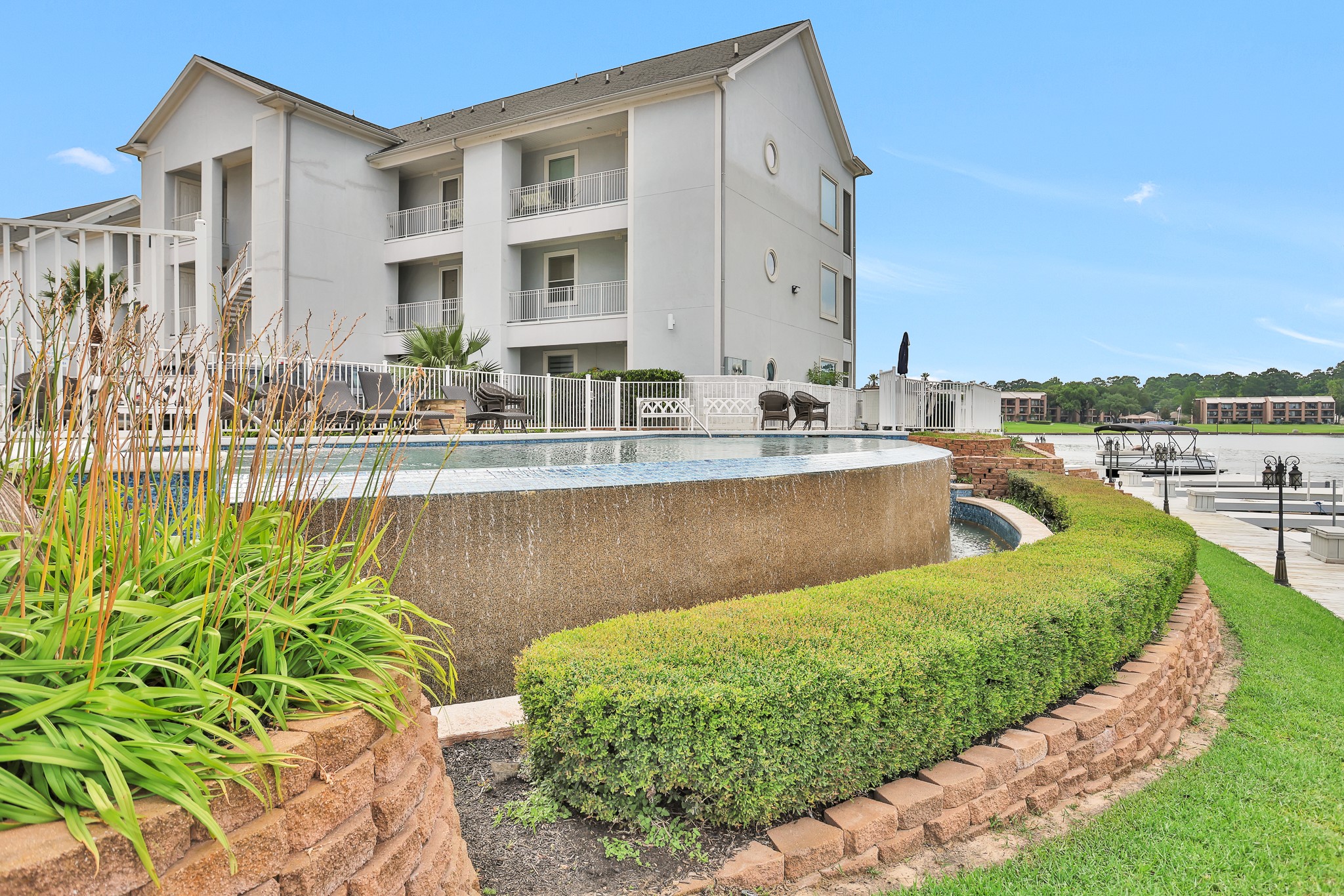 168 Lake Point Boulevard Conroe, TX 77356 - Photo 23 of 24 a view of a house with a swimming pool and sitting area