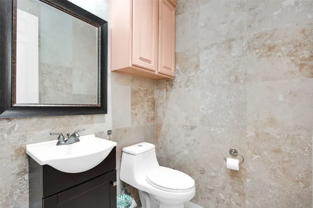 a bathroom with a sink a toilet and mirror