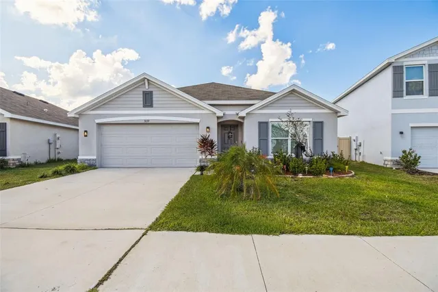 a front view of a house with a garden and plants