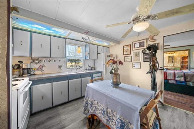 a kitchen with a table chairs stove and cabinets