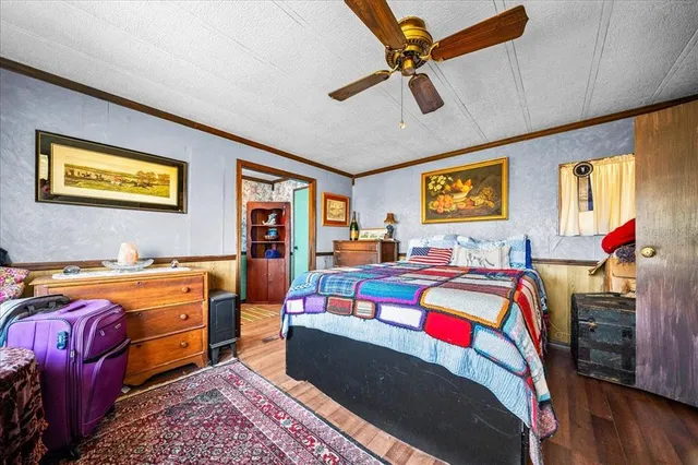a living room with stainless steel appliances furniture and a rug
