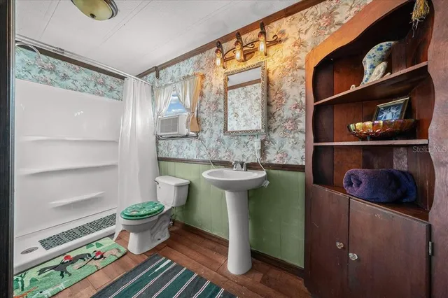 a kitchen with a sink and wooden floor