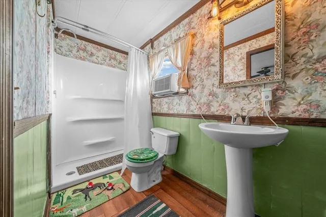 a bathroom with a sink toilet and a mirror
