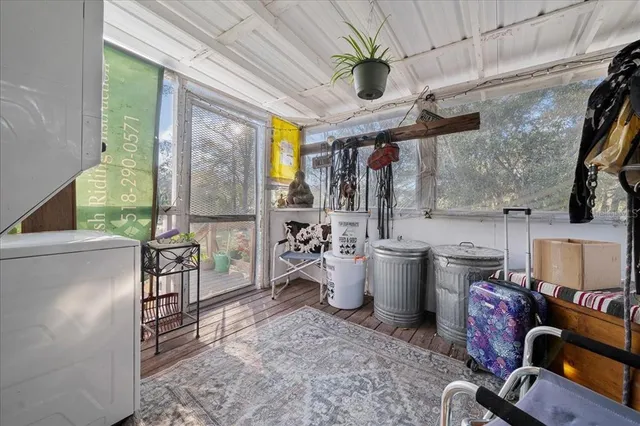 a room with lots of wooden furniture and windows