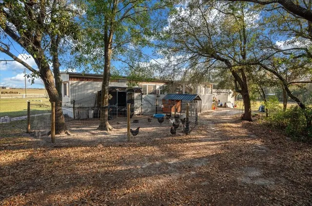 a view of a bike garage next to a yard