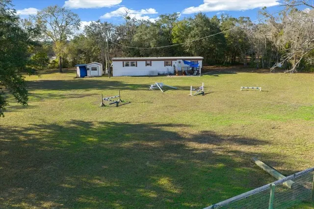 a view of a swimming pool with a yard