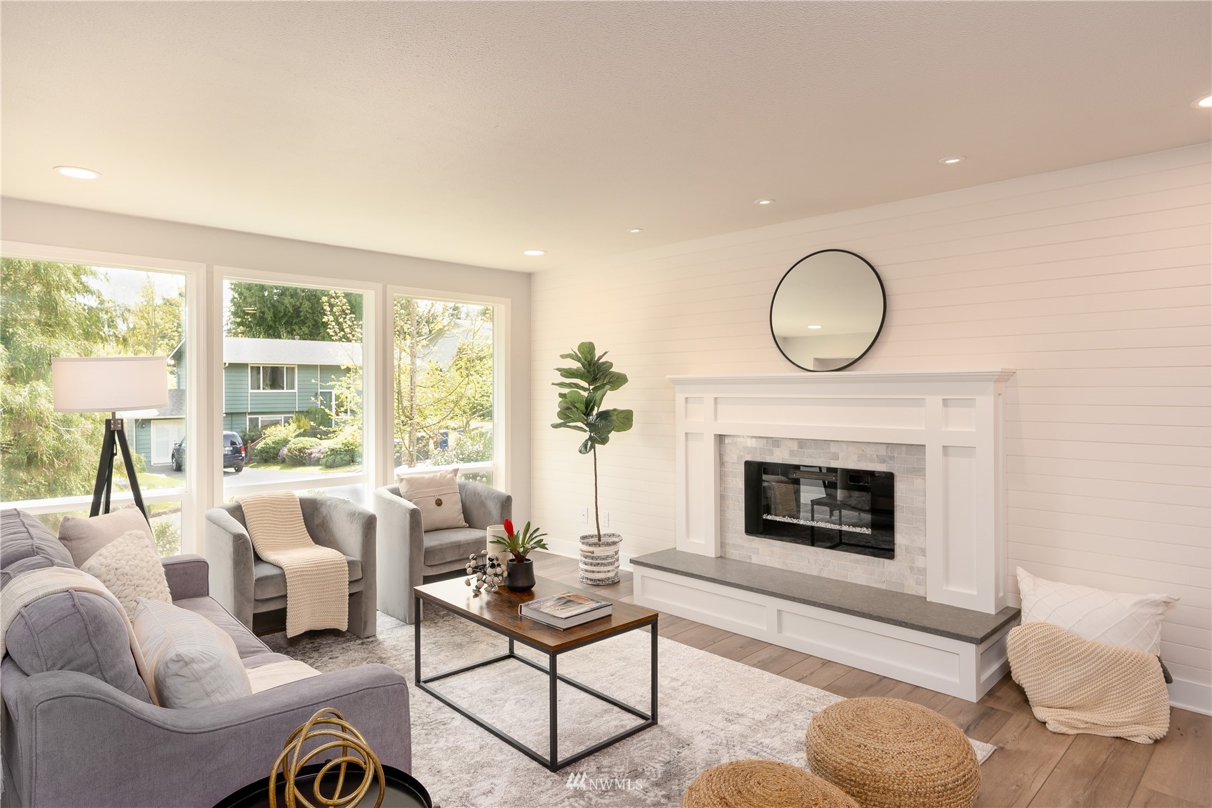 22022 4th Place West Bothell, WA 98021 - Photo 6 of 23 a living room with furniture a fireplace and a large window