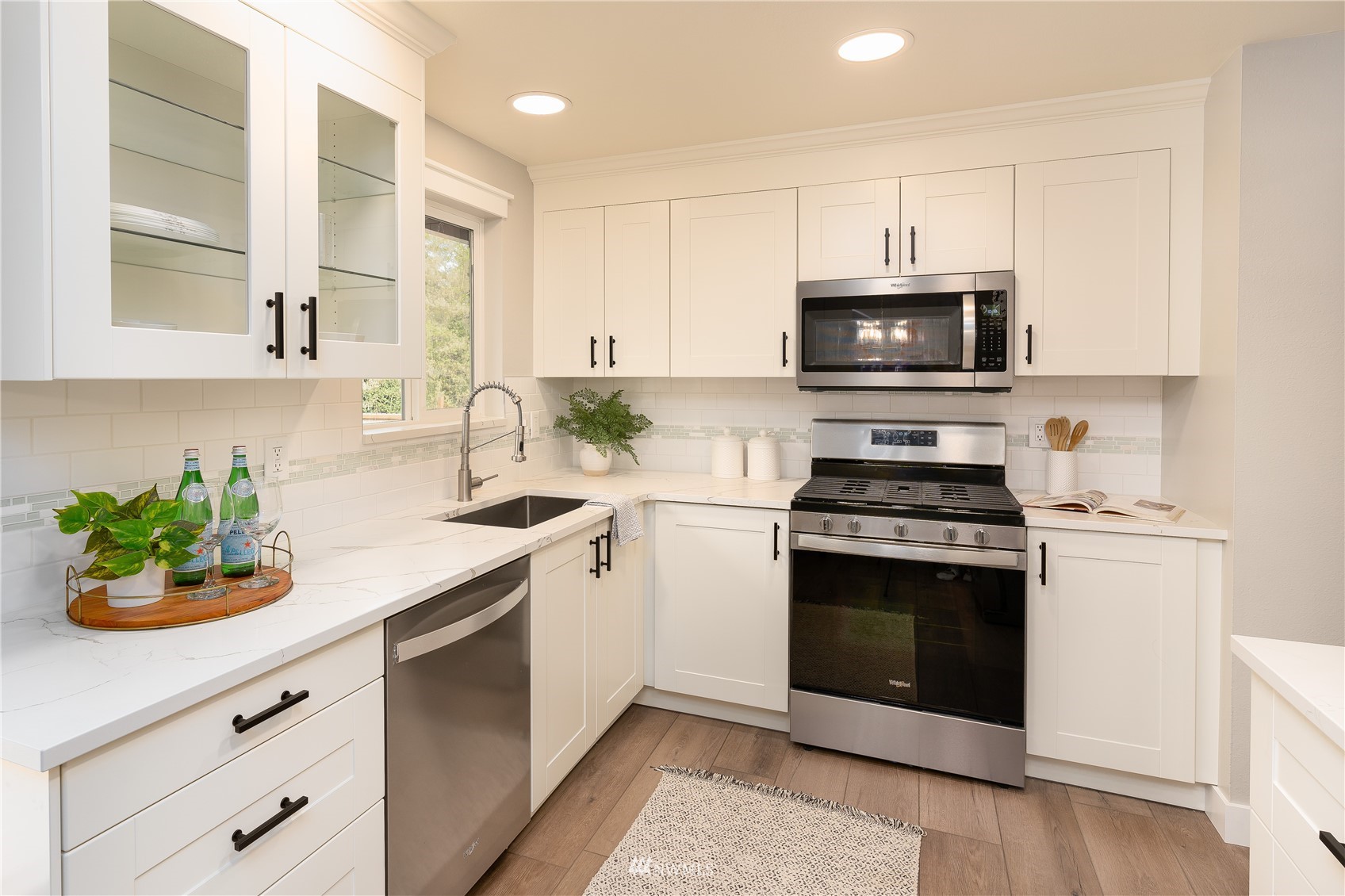 22022 4th Place West Bothell, WA 98021 - Photo 8 of 23 a kitchen with stainless steel appliances white cabinets a stove a sink and a microwave