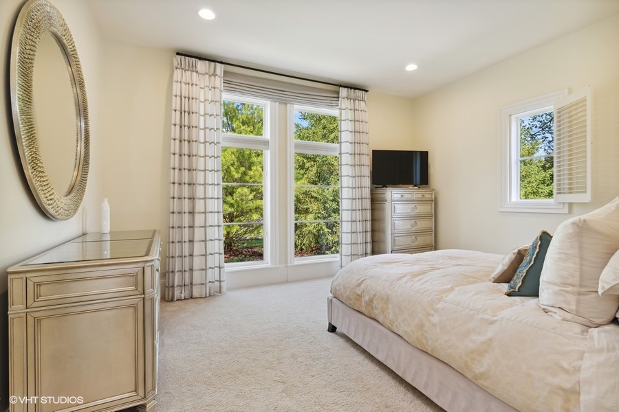 530 South Ridge Road Lake Forest, IL 60045 - Photo 15 of 46 a bedroom with a bed a dresser next to a window