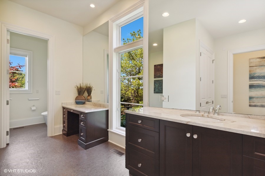 530 South Ridge Road Lake Forest, IL 60045 - Photo 16 of 46 a spacious bathroom with a granite countertop sink and a mirror