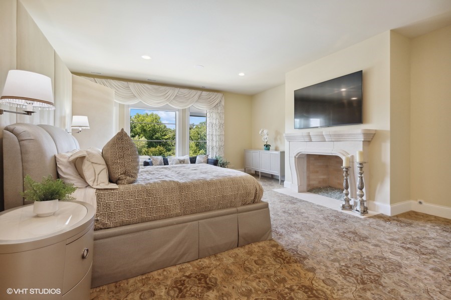 530 South Ridge Road Lake Forest, IL 60045 - Photo 18 of 46 a spacious bedroom with a bed and a flat screen tv