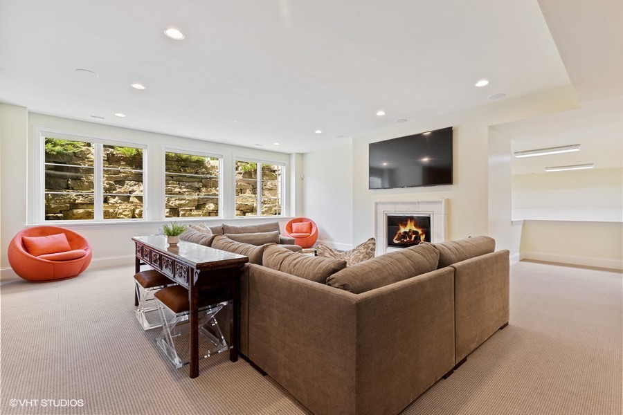 530 South Ridge Road Lake Forest, IL 60045 - Photo 31 of 46 a living room with furniture a fireplace and a flat screen tv