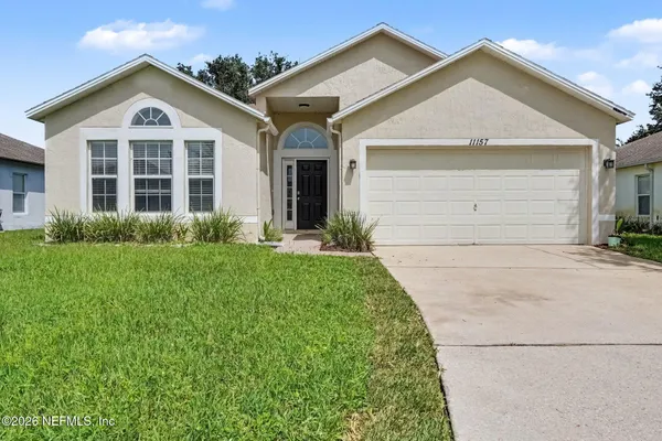 a front view of a house with a yard and garage