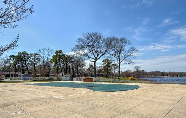 a view of a playground with basketball court