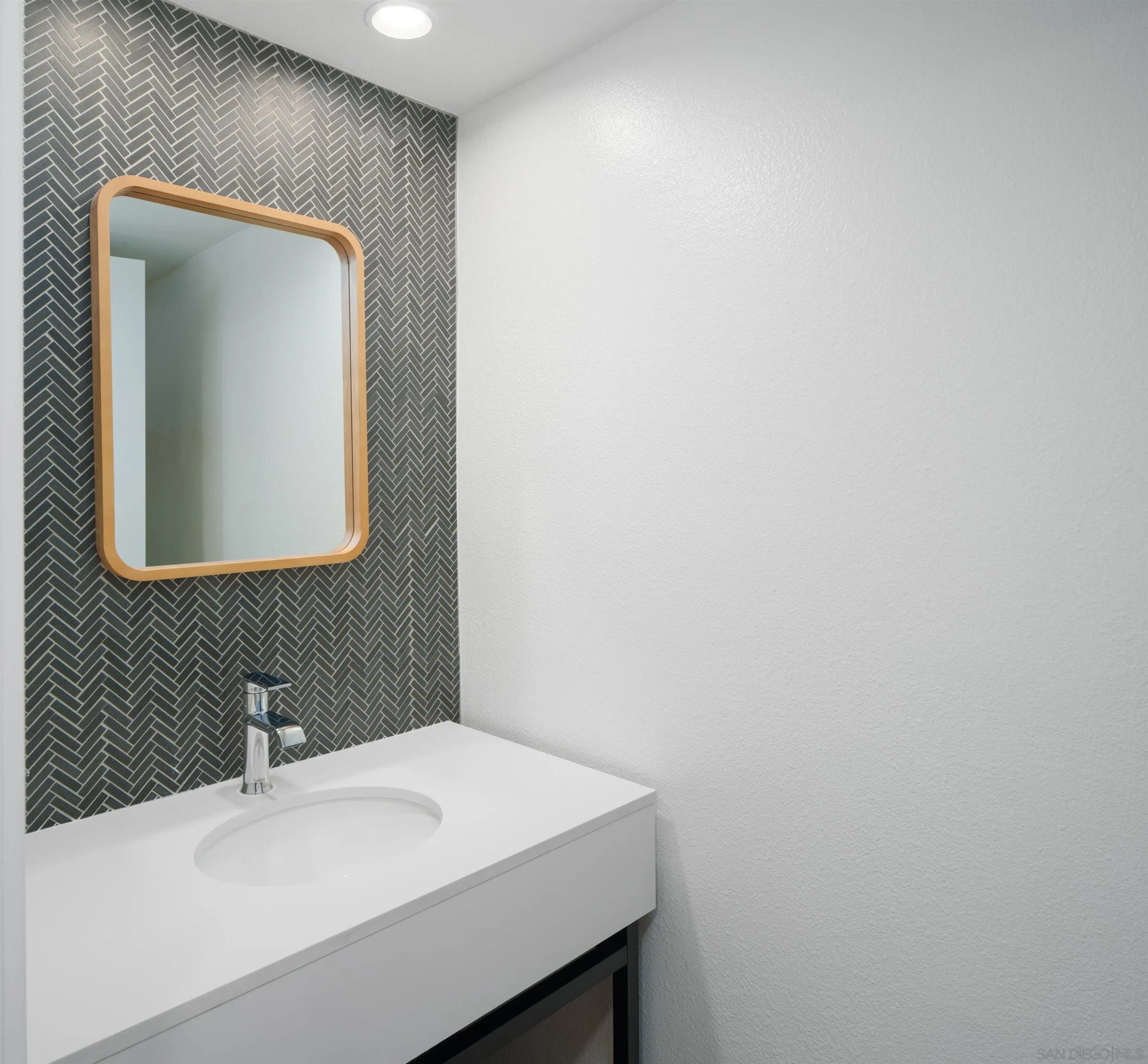 7053 Snapdragon Drive Carlsbad, CA 92011 - Photo 11 of 35 a bathroom with a sink and a mirror