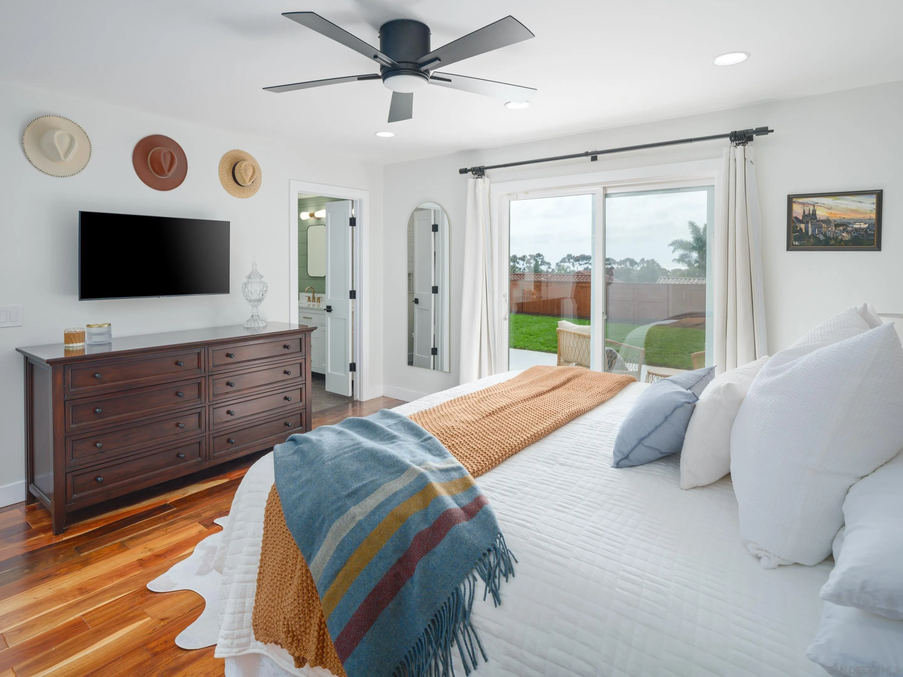 7053 Snapdragon Drive Carlsbad, CA 92011 - Photo 13 of 35 a bedroom with a large bed and a flat tv screen on dresser