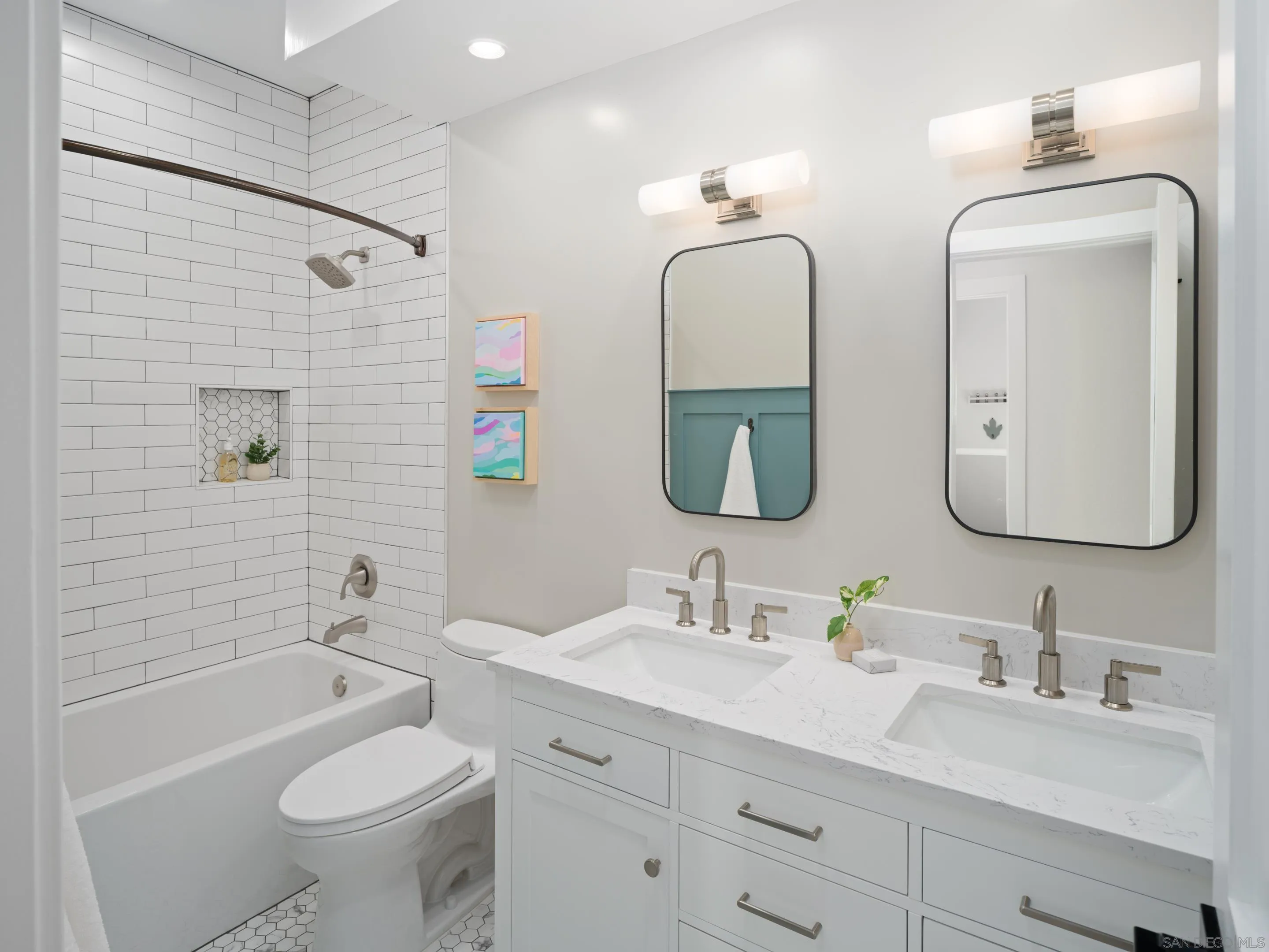 7053 Snapdragon Drive Carlsbad, CA 92011 - Photo 24 of 35 a bathroom with double vanity sinks a toilet a mirror and shower
