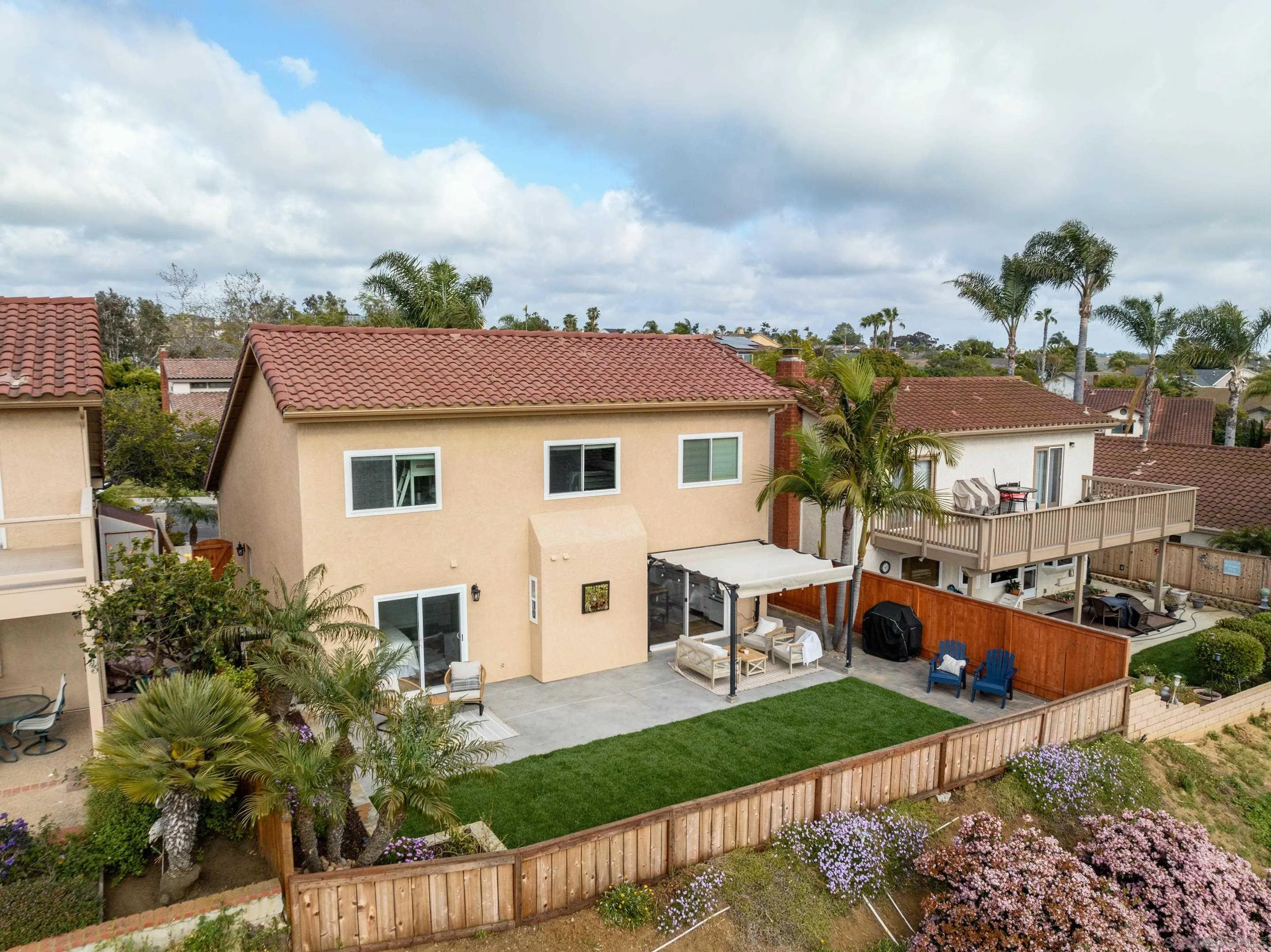 7053 Snapdragon Drive Carlsbad, CA 92011 - Photo 29 of 35 a front view of a house with garden and porch