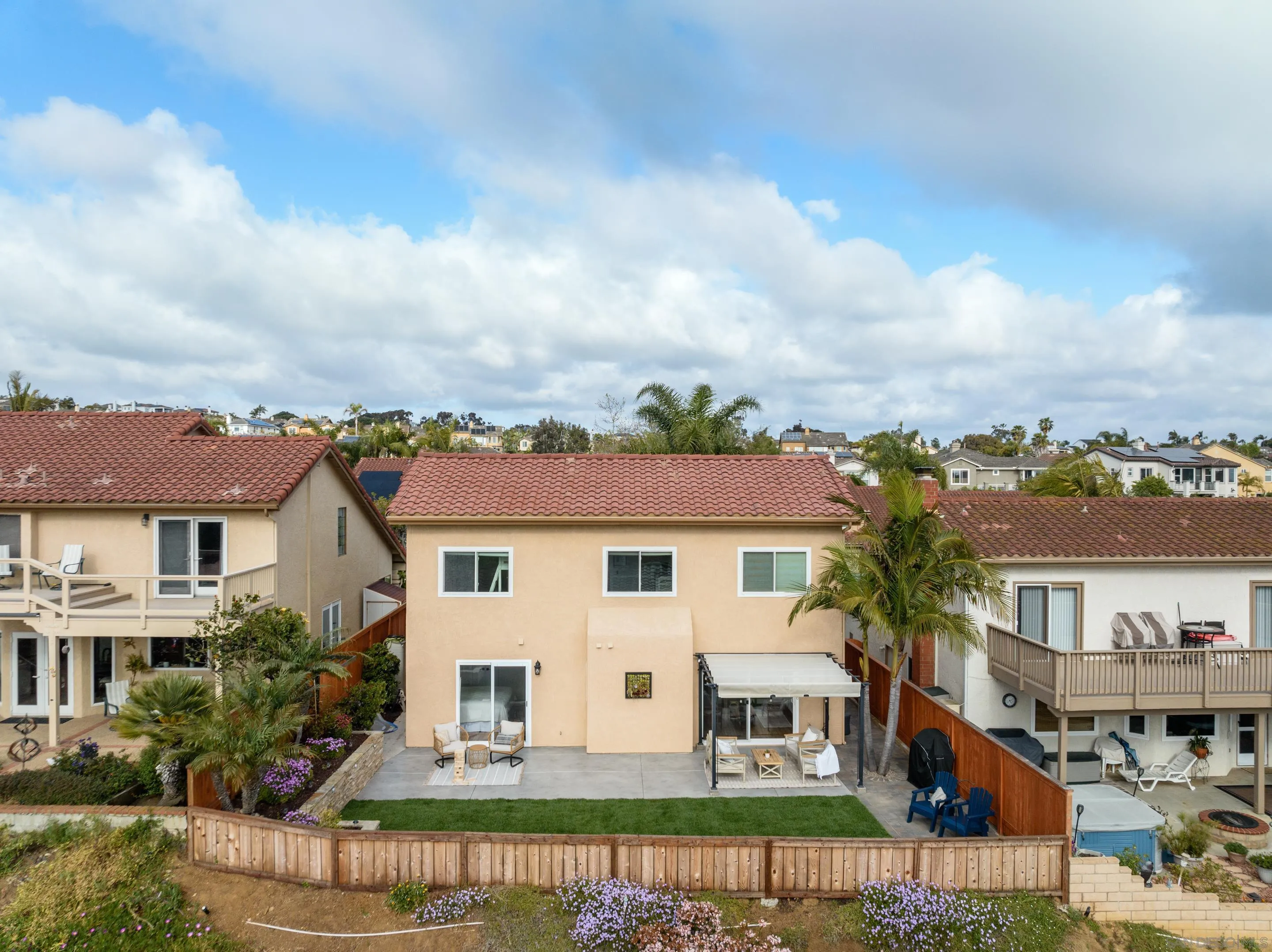 7053 Snapdragon Drive Carlsbad, CA 92011 - Photo 30 of 35 a view of a white house with a big yard and potted plants