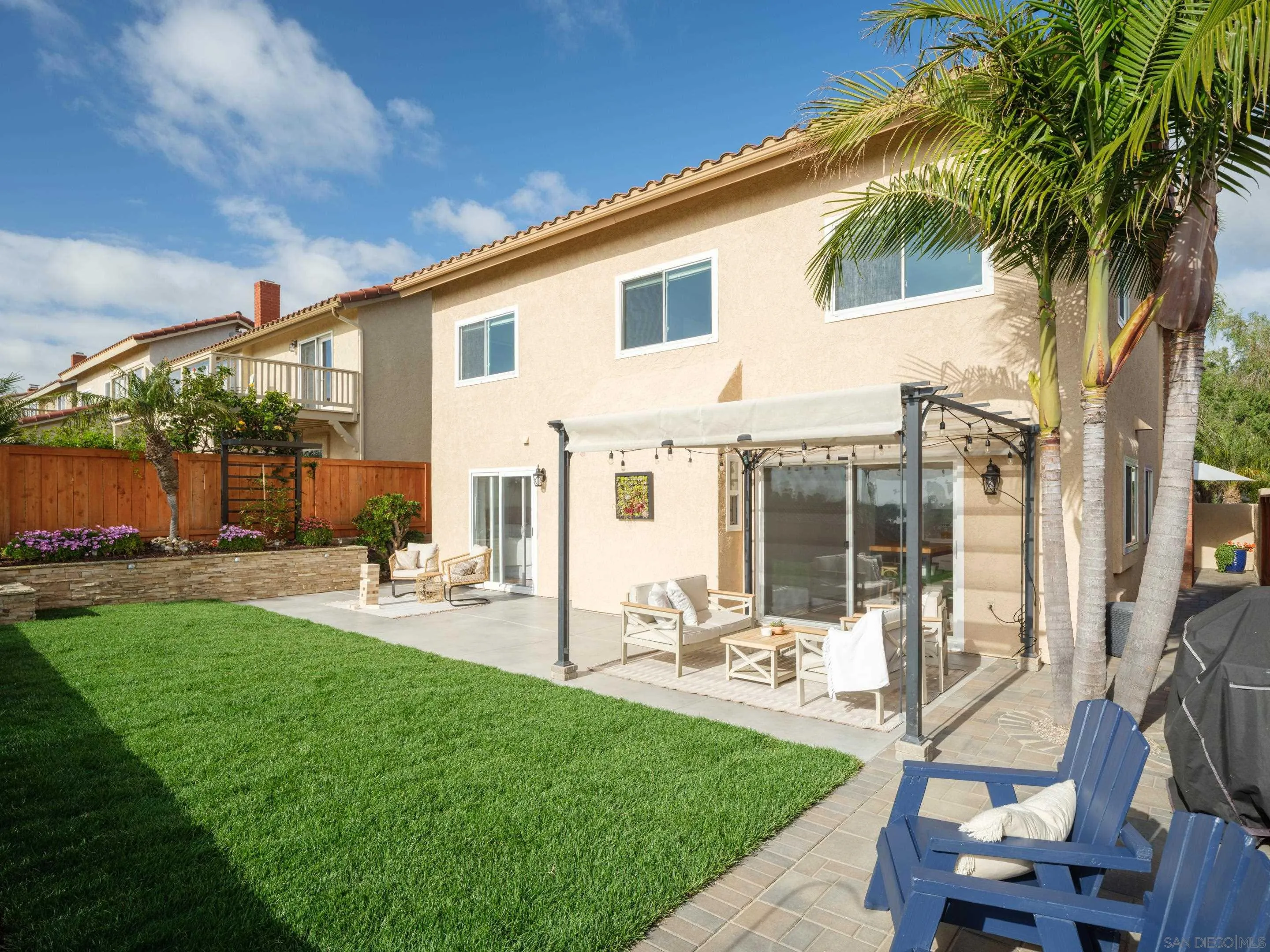 7053 Snapdragon Drive Carlsbad, CA 92011 - Photo 32 of 35 a front view of a house with a yard patio and fire pit