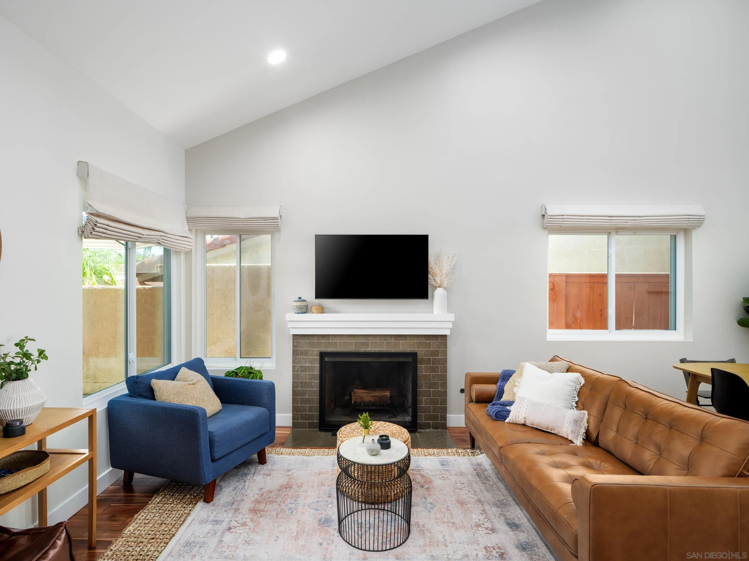 7053 Snapdragon Drive Carlsbad, CA 92011 - Photo 5 of 35 a living room with furniture a flat screen tv and a fireplace