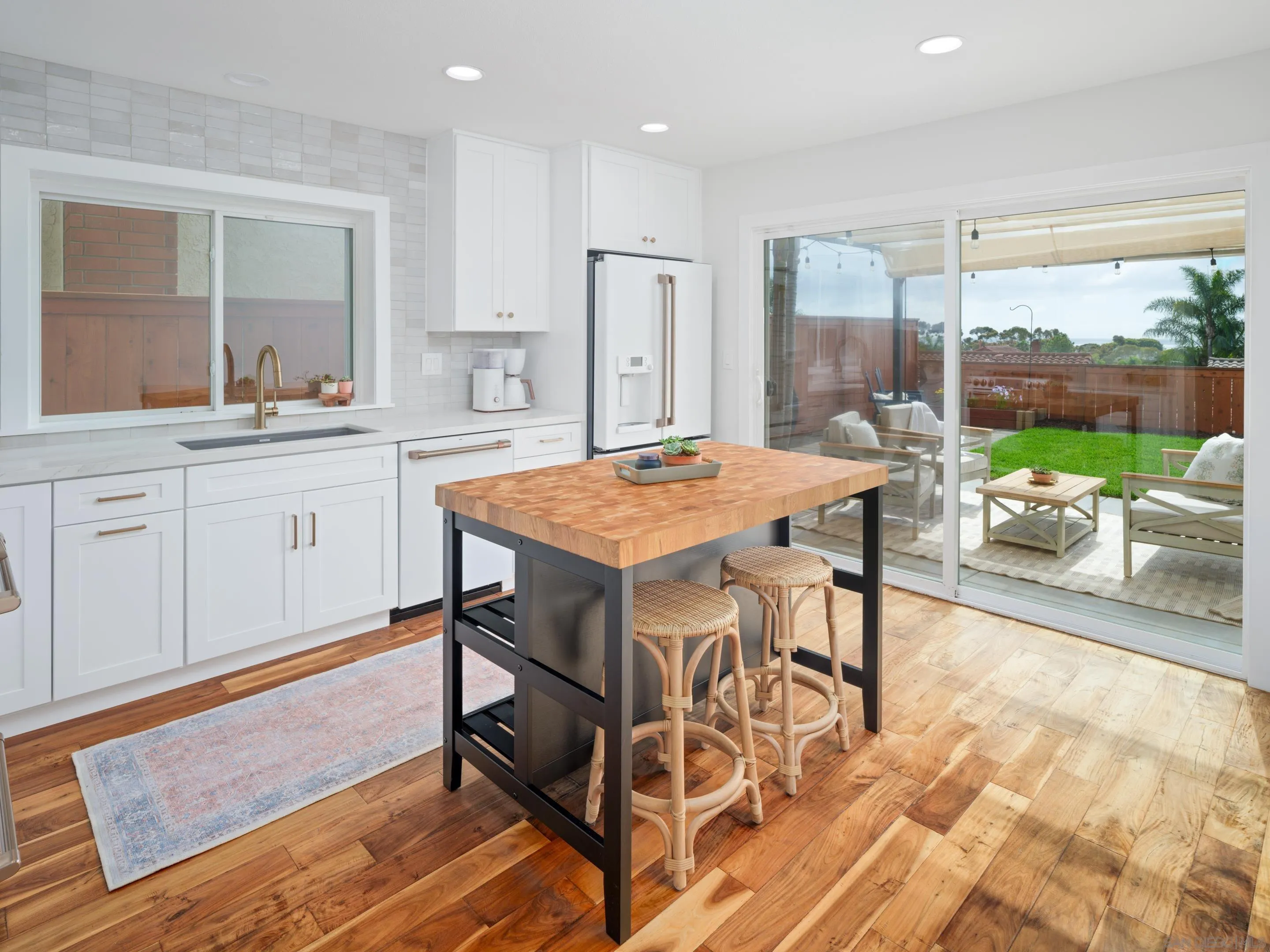 7053 Snapdragon Drive Carlsbad, CA 92011 - Photo 8 of 35 a open kitchen with a table and chairs in it